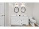 Double vanity bathroom with tiled flooring and oval mirrors at 521 N Franklin Dr, Sanford, NC 27330
