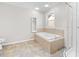 Bathroom features a soaking tub, shower, and tiled flooring at 521 N Franklin Dr, Sanford, NC 27330