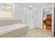 Bathroom with a soaking tub, shower, and tiled flooring at 521 N Franklin Dr, Sanford, NC 27330