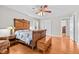 Bedroom with hardwood floors, antique bed, and access to another room at 521 N Franklin Dr, Sanford, NC 27330