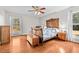 Spacious bedroom with hardwood floors, large windows, and antique wooden bed at 521 N Franklin Dr, Sanford, NC 27330
