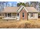 Charming single-story home with a brick facade, covered porch, and cozy curb appeal at 521 N Franklin Dr, Sanford, NC 27330