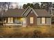 Charming single-story home with a brick facade, covered porch, and cozy curb appeal at 521 N Franklin Dr, Sanford, NC 27330