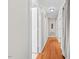 Hardwood floors in a long hallway with doors to bedrooms and bathroom at 521 N Franklin Dr, Sanford, NC 27330