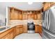Modern kitchen with wood cabinets and stainless steel appliances at 521 N Franklin Dr, Sanford, NC 27330