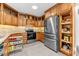 Kitchen with wood cabinets, pull-out shelving and stainless steel appliances at 521 N Franklin Dr, Sanford, NC 27330