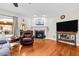 Living room features hardwood floors, fireplace and a view to backyard at 521 N Franklin Dr, Sanford, NC 27330
