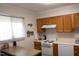 Kitchen with wood cabinets and white appliances at 6 Shepherd Ln # Blgd C, Chapel Hill, NC 27514