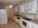 Kitchen with white cabinets, appliances, and tiled floor at 626 Pine Ridge Pl Pl, Raleigh, NC 27609