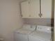 Laundry room with washer, dryer, and upper cabinets at 626 Pine Ridge Pl Pl, Raleigh, NC 27609