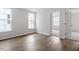 Well-lit bedroom with hardwood floors and two windows with views of the outside at 708 Georgias Landing Pkwy # 14, Raleigh, NC 27603