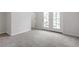 Spacious carpeted bedroom with neutral colors and a door to the outside balcony at 708 Georgias Landing Pkwy # 14, Raleigh, NC 27603