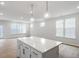 Bright open kitchen featuring a white island with pendant lighting and spacious living area at 708 Georgias Landing Pkwy # 14, Raleigh, NC 27603