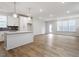 Open floor plan showcasing the kitchen, hardwood floors, and natural light from large windows at 708 Georgias Landing Pkwy # 14, Raleigh, NC 27603