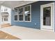 View of the exterior patio featuring blue siding and white trim with a door and 3 windows at 708 Georgias Landing Pkwy # 14, Raleigh, NC 27603