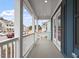 View of the outdoor porch with decorative columns and blue siding with black shutters at 708 Georgias Landing Pkwy # 14, Raleigh, NC 27603