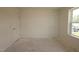 Bedroom with a window and two white doors offering natural light and privacy at 7113 Hubner Pl # 20, Cary, NC 27519