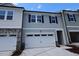View of the exterior of a two-story home with a white garage door at 7113 Hubner Pl # 20, Cary, NC 27519