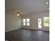 Bright living room with wood-look flooring and multiple windows for natural light at 7113 Hubner Pl # 20, Cary, NC 27519