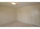 A well-lit room featuring white walls, concrete floors, ceiling light, and a door at 7113 Hubner Pl # 20, Cary, NC 27519