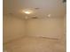 A large room with white walls, concrete floors, and a ceiling light in a house for sale at 7113 Hubner Pl # 20, Cary, NC 27519