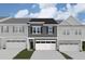 New home with a gray exterior, a two-car garage, and dark shutters at 7115 Hubner Pl # 21, Cary, NC 27519