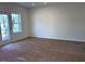 Bright living room with a window and door letting in plenty of natural light at 7115 Hubner Pl # 21, Cary, NC 27519