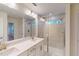 Bathroom featuring double sinks, modern shower, and plenty of lighting at 7117 Hubner Pl # 22, Cary, NC 27519