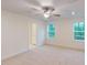 Carpeted bedroom with a ceiling fan, natural light, and an ensuite bath at 7117 Hubner Pl # 22, Cary, NC 27519