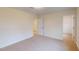 Neutral carpeted bedroom provides entrances to the other parts of the house at 7117 Hubner Pl # 22, Cary, NC 27519
