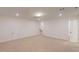 A neutral bedroom provides access to stairs and a hallway at 7117 Hubner Pl # 22, Cary, NC 27519
