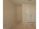 Empty bedroom featuring double door closet and a single door at 7117 Hubner Pl # 22, Cary, NC 27519