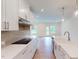 Modern kitchen boasts white cabinets, stainless steel appliances, and an open layout at 7117 Hubner Pl # 22, Cary, NC 27519
