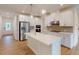 Bright, spacious kitchen with white cabinets, center island, and stainless steel appliances at 7117 Hubner Pl # 22, Cary, NC 27519