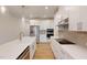 Bright modern kitchen with white cabinets, stainless steel appliances and quartz countertops at 7117 Hubner Pl # 22, Cary, NC 27519