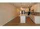 Open-concept kitchen with island, stainless steel appliances and bright pendant lighting at 7117 Hubner Pl # 22, Cary, NC 27519