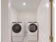 Modern white laundry room with stacked washer and dryer for space saving at 7117 Hubner Pl # 22, Cary, NC 27519