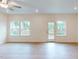 Bright living area features hardwood floors, recessed lights, rear patio access, and nature views at 7117 Hubner Pl # 22, Cary, NC 27519