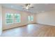 Bright and airy living room with hardwood floors, ceiling fan, recessed lights, and nature views at 7117 Hubner Pl # 22, Cary, NC 27519