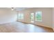 Bright living room featuring hardwood floors, recessed lights, large windows, and a backyard view at 7117 Hubner Pl # 22, Cary, NC 27519
