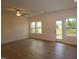 Spacious living room featuring wood floors, a ceiling fan, and a back door to the outside at 7117 Hubner Pl # 22, Cary, NC 27519