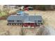 Aerial view of a gray house, pool, and detached shed at 7228 Pecan Tree St, Willow Springs, NC 27592