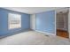 Light blue bedroom with window and closet at 7228 Pecan Tree St, Willow Springs, NC 27592