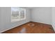 Simple bedroom with hardwood floors and a window at 7228 Pecan Tree St, Willow Springs, NC 27592