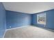 Blue-walled bedroom with a window at 7228 Pecan Tree St, Willow Springs, NC 27592