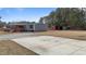 House exterior, featuring gray siding and a large concrete driveway at 7228 Pecan Tree St, Willow Springs, NC 27592