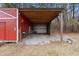 Open-air storage area attached to a red shed at 7228 Pecan Tree St, Willow Springs, NC 27592