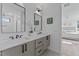 Modern bathroom with double vanity, sleek fixtures, and a view of the bedroom at 808 Culpepper Ln, Raleigh, NC 27610