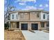 Modern duplex with two-car garages and neutral color brick and siding at 808 Culpepper Ln, Raleigh, NC 27610