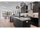 Modern kitchen with island, stainless steel appliances, and dark cabinetry at 808 Culpepper Ln, Raleigh, NC 27610